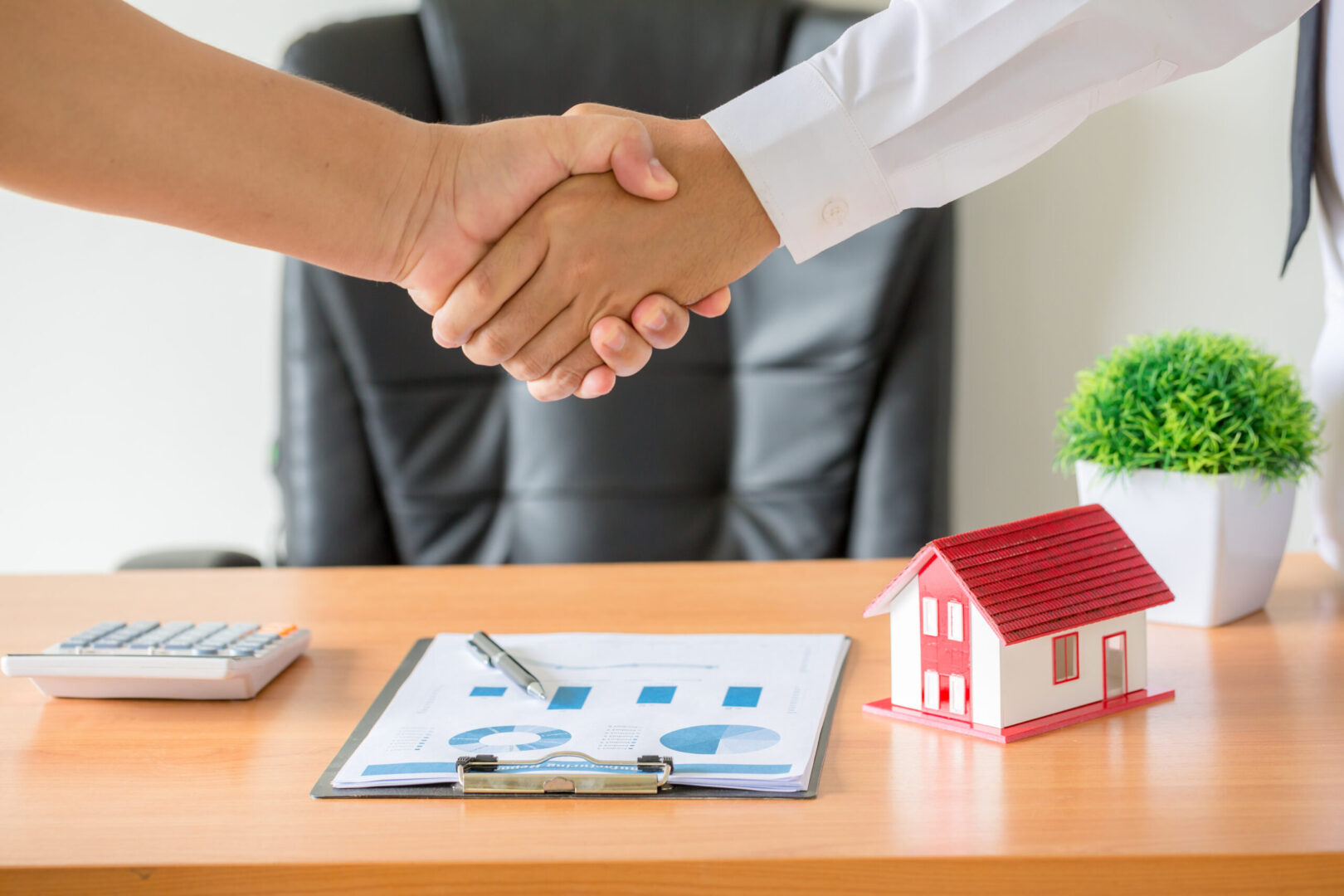 hands agent client shaking hands after signed contract buy new apartment scaled